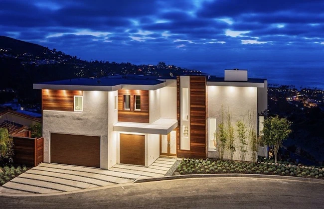 Luxurious San Diego home post-remodel with modern design illuminated at twilight.