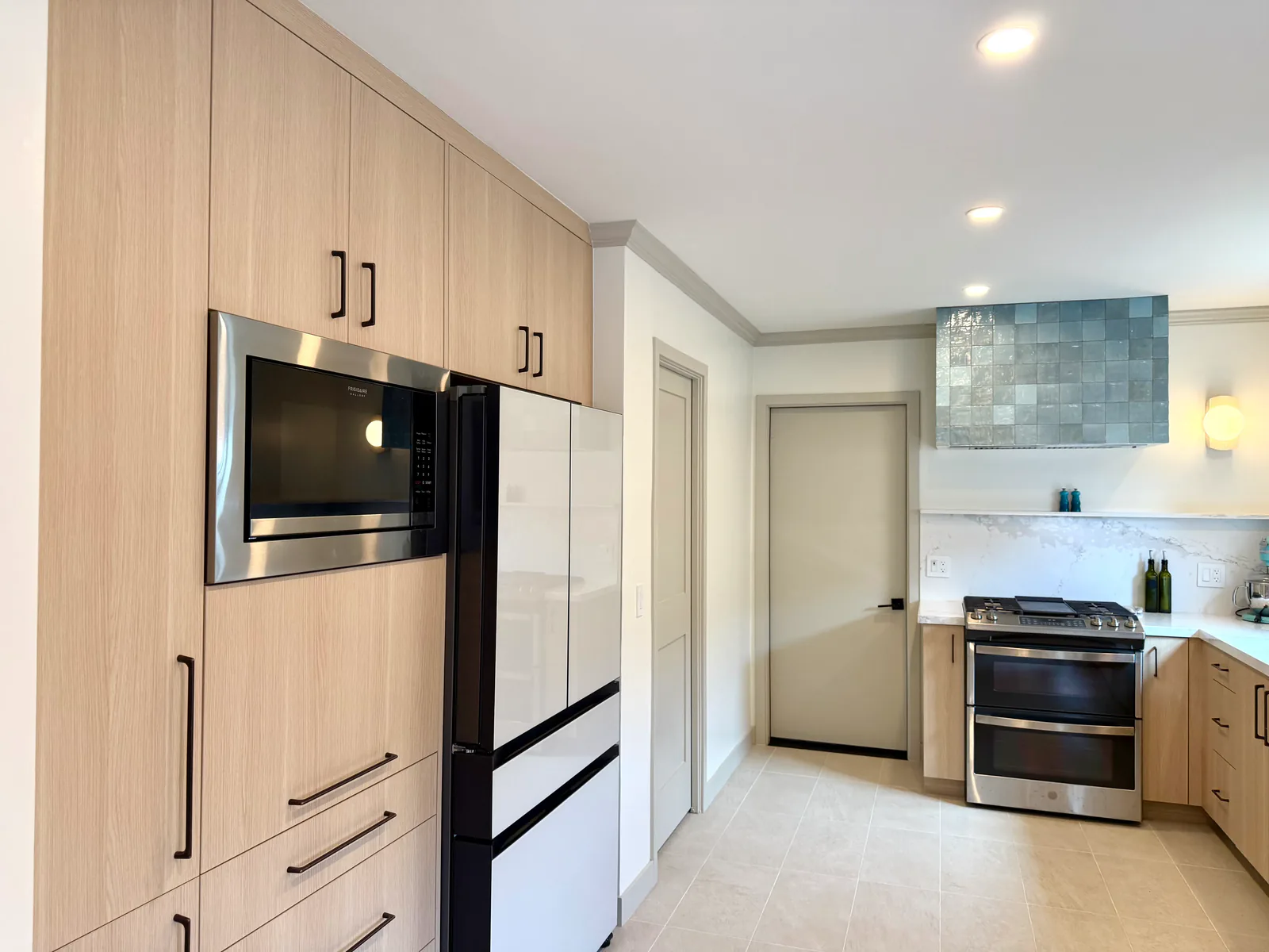 Floor-to-ceiling pantry wall with panel-ready refrigerator and built-in microwave