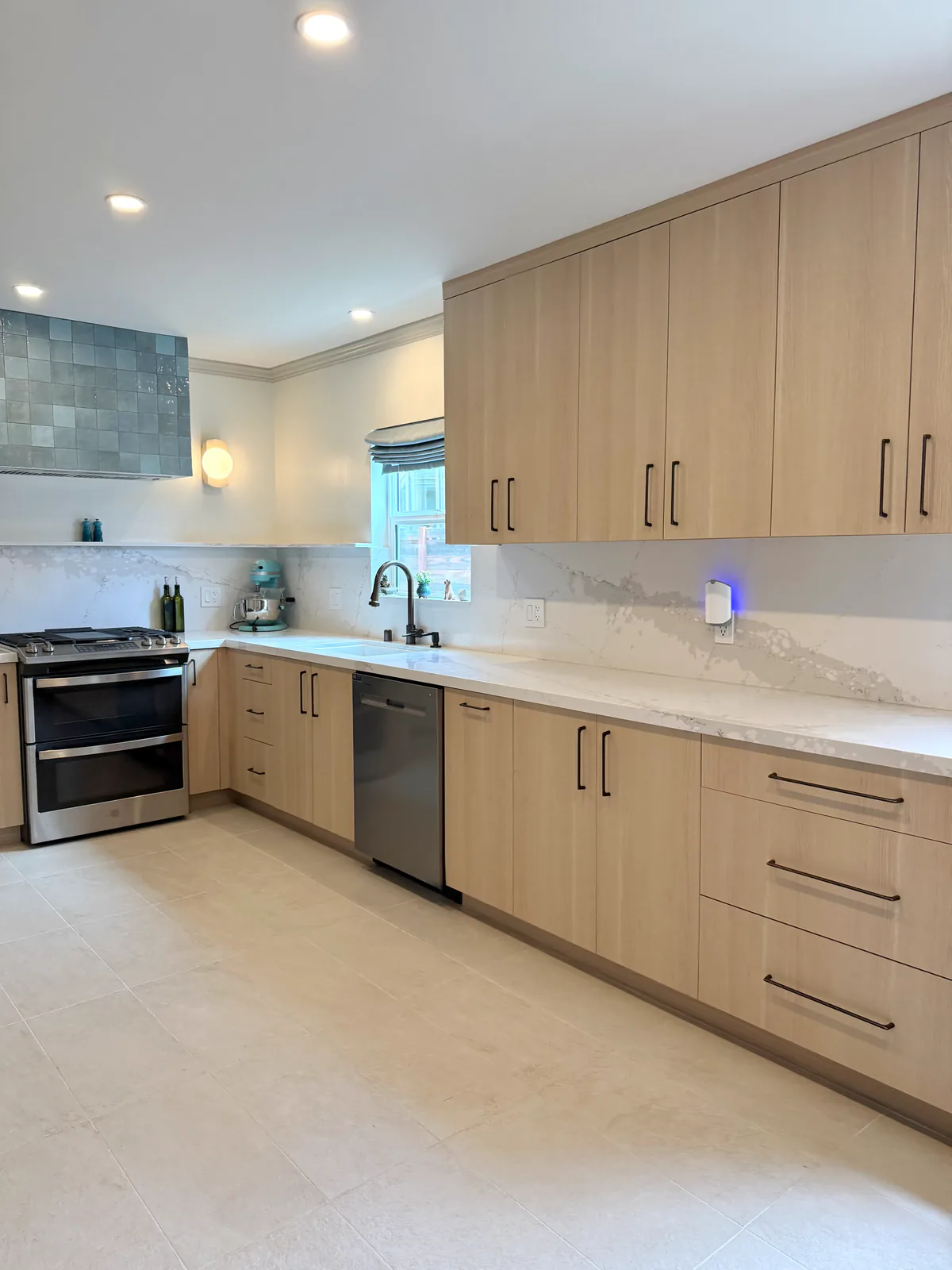 Quartz counter and full-slab backsplash along the sink wall