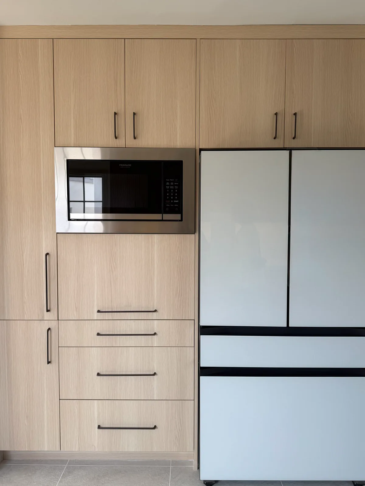 Tall cabinet run with integrated microwave and drawer stack
