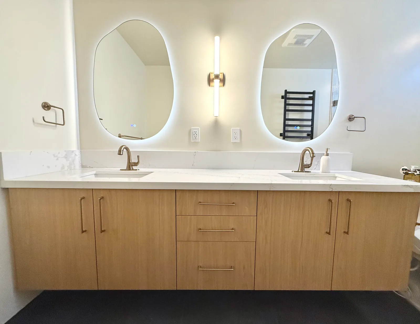 Primary bath floating double vanity with backlit mirrors